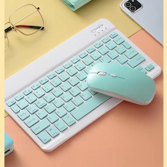 Teal keyboard and mouse set on a yellow and pink surface