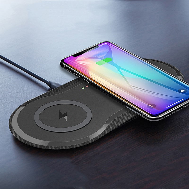 Wireless charging pad with a smartphone on a dark surface